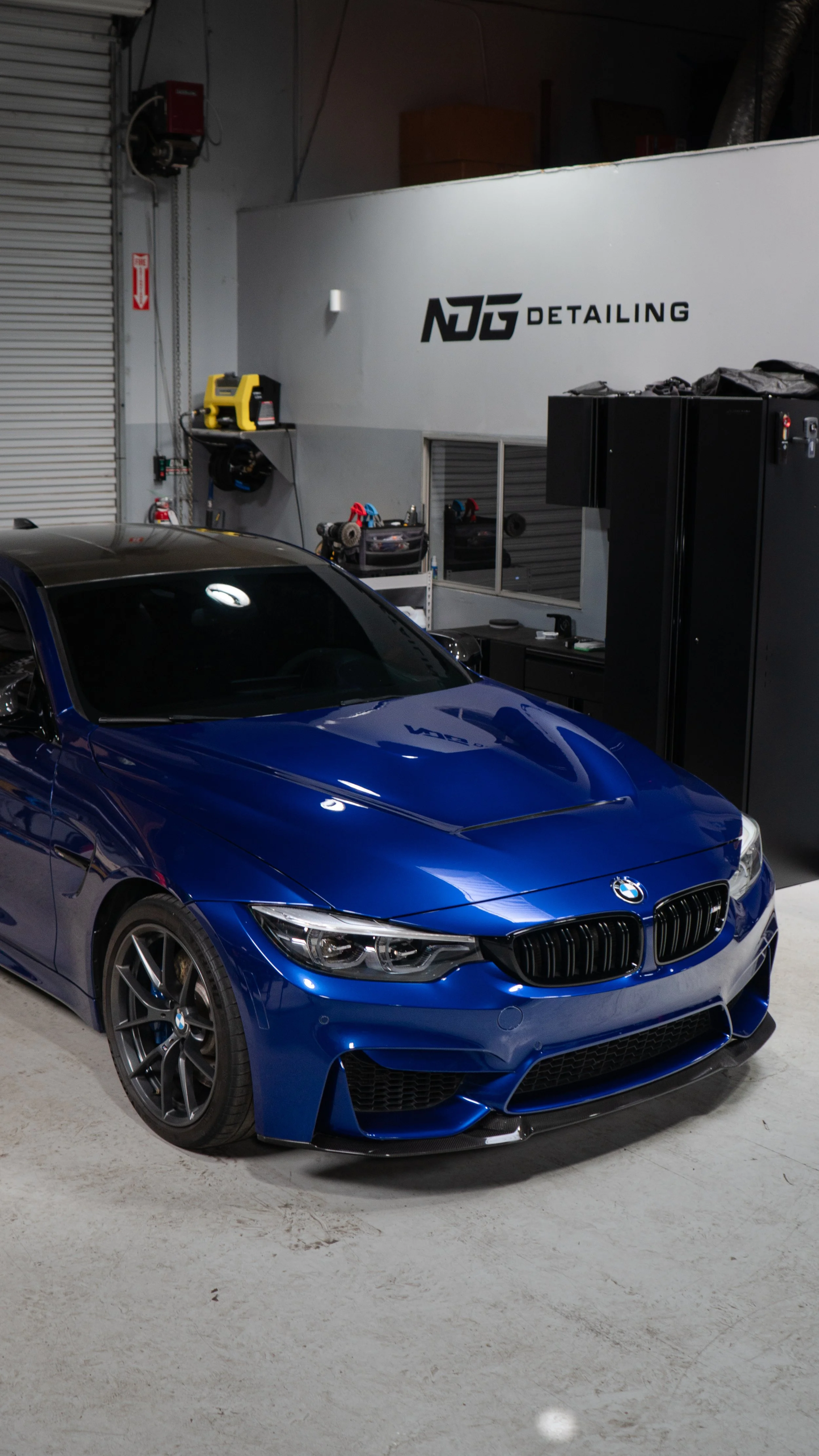 Blue BMW mid-detail in the NDG Detailing shop